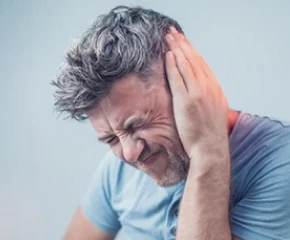 Persona con ronzio all'orecchio, sintomo di acufene